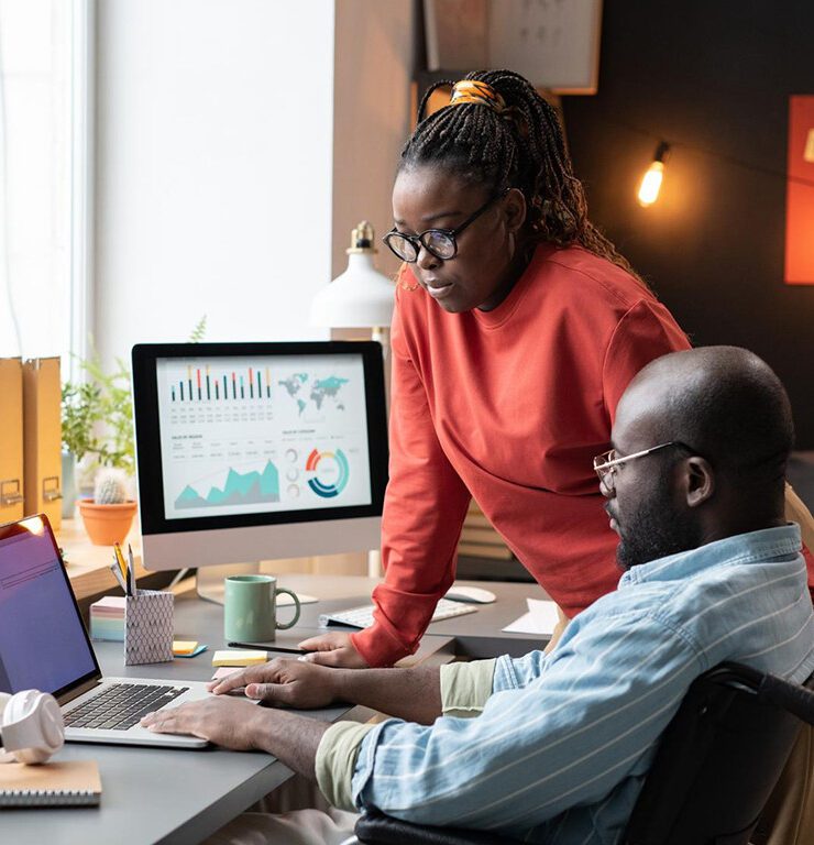 A diverse team of digital strategists gathering around a large, glowing interactive touch-table displaying website user behavior heatmaps, conversion data analytics, and user flow charts in a modern, dark-themed studio with user journey whiteboards in the background.