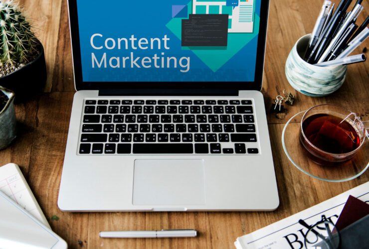 A laptop with 'Content Marketing' on screen at a desk workspace, illustrating content strategy